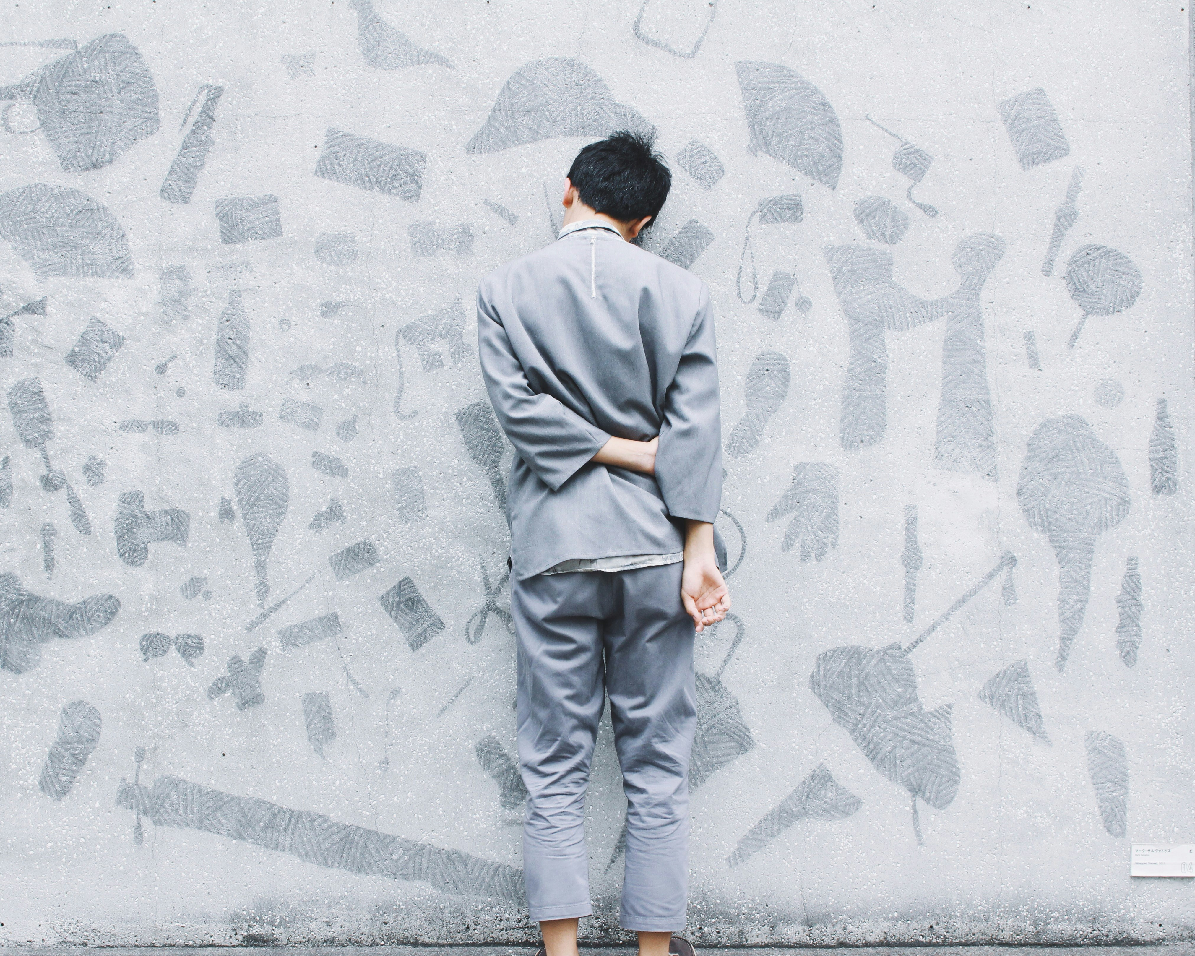 man standing in front of wall